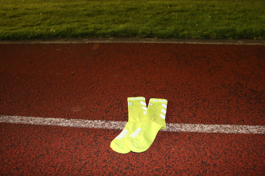 Reflective sport socks to be used by athletes for exercise and sports. These sportswear socks are cotton with reflective text and logos embodied into them for reflective purposes to aid visibility whilst performing exercise activities in the dark. At dusk, dawn or night. TRUE REFLECTION.